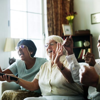 Senior people watching televison together