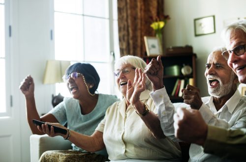 Senior people watching televison together